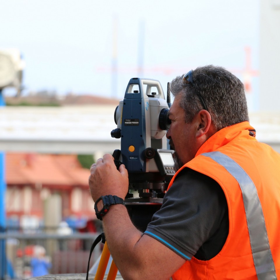 Worker surveying land